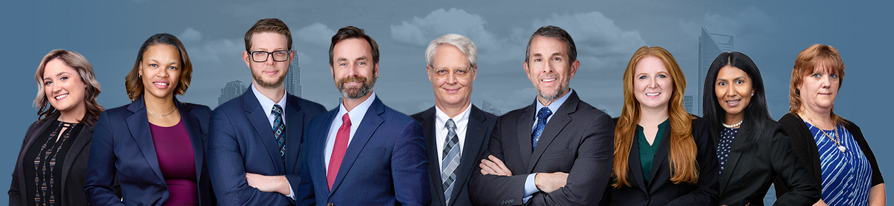 Photo of the Attorneys over a Charlotte, North Carolina's skyline